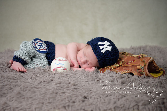 newborn boy with baseball glove